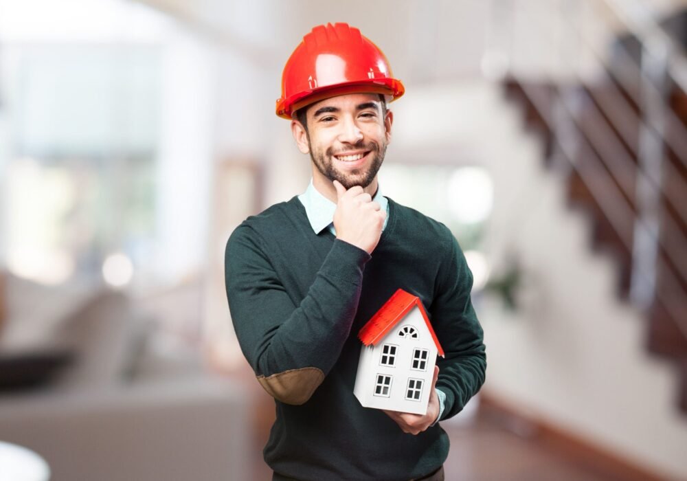 man-with-red-helmet-small-house-hand